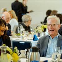 President Philomena V. Mantella sitting and laughing with guests at the Foundation Annual Meeting